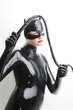© Richard Semik - portrait of standing woman wearing latex clothes with a whip