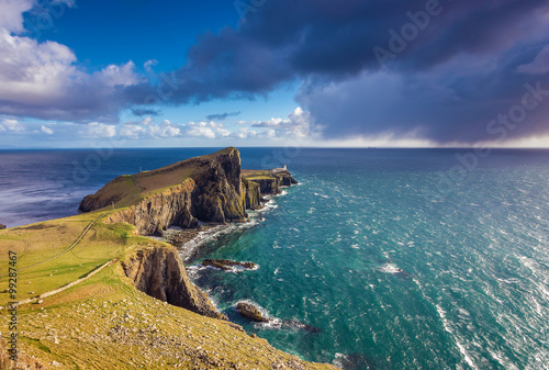 Fotomural Dark clouds at Neist Point Lighthouse minutes before a heavy strom on the Isle o
