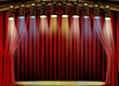 Empty stage with red curtain and spot lights
