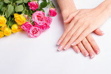 French Manicure With Pink And Yellow Roses On A White Background