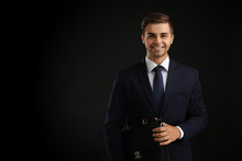 Elegant Man In Suit With Briefcase On Dark Background