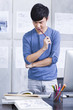 © Blue Jean Images - Young man working in the office