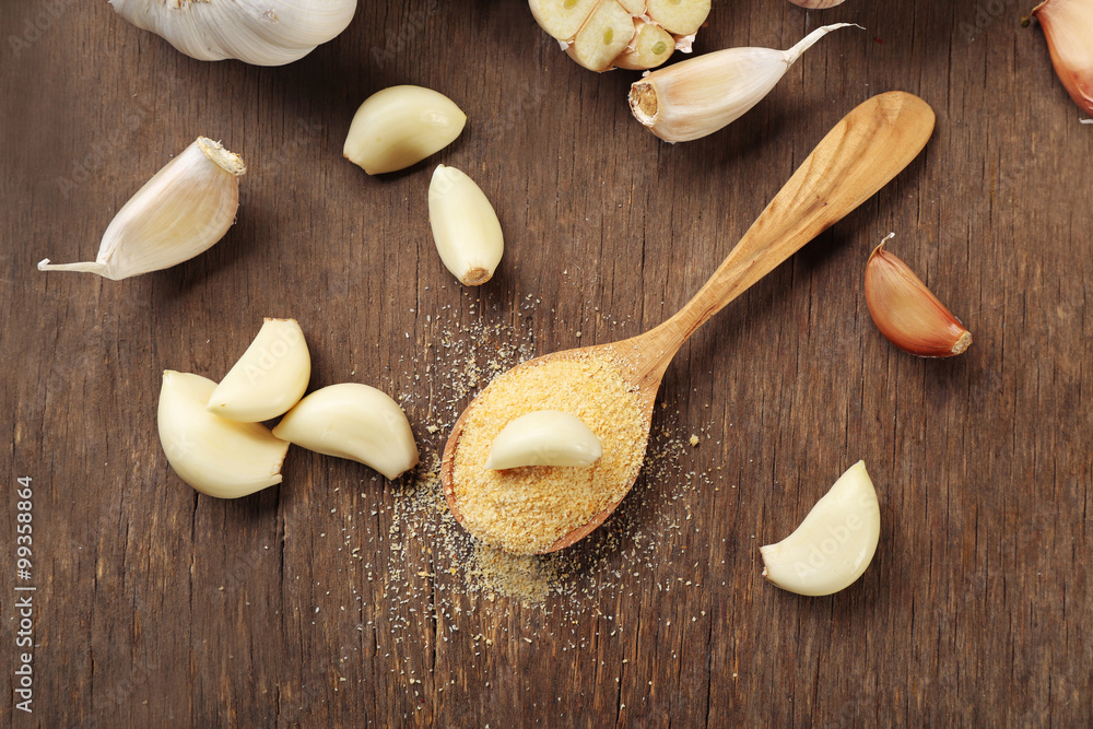 Composition of garlic and rosemary on wooden background