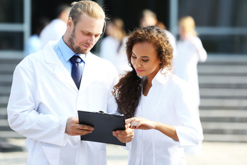 Canvas Print - Medical concept - two doctors with stethoscopes and prescription clipboard