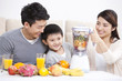 © Blue Jean Images - Happy family making juice with electric juicer