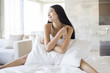 © Blue Jean Images - Beautiful young woman on bed
