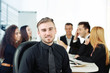 © Africa Studio - Photo of a young business man with his staff at the meeting in a conference room