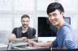 © Blue Jean Images - Young man with colleague in office