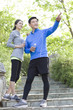 © Blue Jean Images - Happy mature couple holding bottled water after exercising