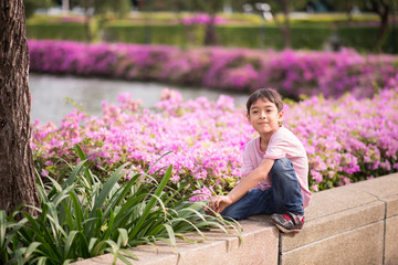 Wall Mural - Little boy sitting in the garden