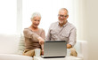 © Syda Productions - happy senior couple with laptop and cups at home