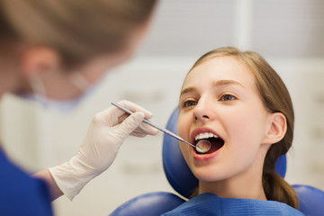 Poster - female dentist checking patient girl teeth