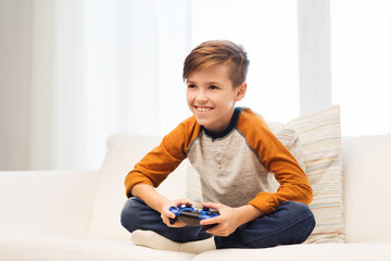 Poster - happy boy with joystick playing video game at home