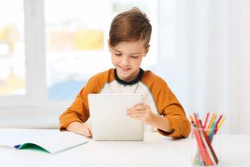 Poster - smiling boy with tablet pc and notebook at home