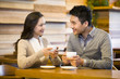 © Blue Jean Images - Young couple chatting in cafe