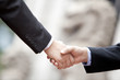 © Blue Jean Images - Close up of businessmen shaking hands, Hong Kong