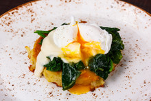 The Poached Egg On The Cutlet From Potatoes With Spinach.
