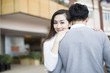 © Blue Jean Images - Young couple embracing in shopping mall