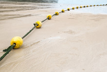 Yellow Buoy And Rope On The Beach