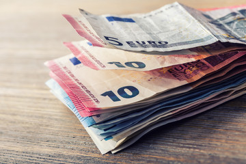 Wall Mural - Several hundred euro banknotes stacked by value. Euro money concept. Euro banknotes. Euro money. Euro currency. Banknotes stacked on each other in different positions. Toned photo