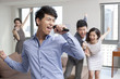 © Blue Jean Images - Happy young friends singing and dancing in living room