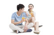 © Blue Jean Images - Happy young couple drinking juice