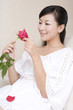 © Blue Jean Images - Asian woman with rose