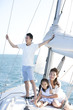 © Blue Jean Images - Happy family on a sailboat