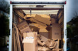 © iredding01 - Removal van with untidy boxes dumped inside. A removal lorry is filled with carelessly thrown boxes