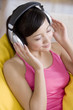 © Blue Jean Images - Asian woman listening to music