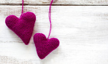 Crochet Pink Hearts On Wooden Background