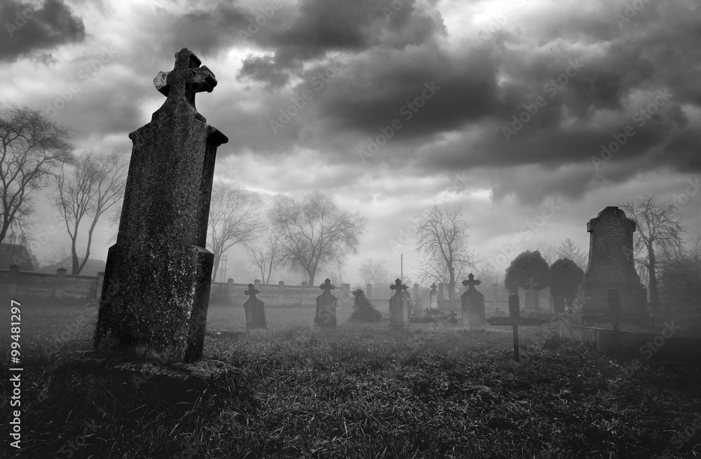 Old creepy graveyard on stormy winter day in black and white - obrazy, fototapety, plakaty 