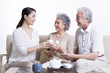 © Blue Jean Images - Happy family having tea and chatting