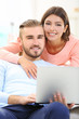 © Africa Studio - Happy couple working on laptop in a room