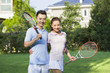 Portrait of young couple with tennis rackets
