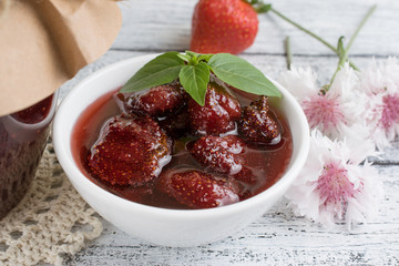 Wall Mural - Canned strawberry confiture and jam sandwich on the wooden board