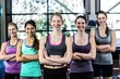 © WavebreakmediaMicro - Smiling women posing together with arms crossed