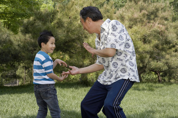 Grandson And Grandfather Practicing Kung Fu