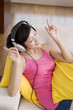 © Blue Jean Images - Asian woman listening to music