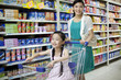 © Blue Jean Images - Mother and daughter shopping in supermarket