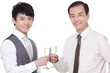 © Blue Jean Images - Businessmen with champagne flutes toasting