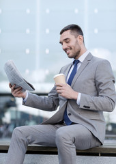 Canvas Print - young businessman with coffee and newspaper