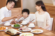 © Blue Jean Images - Happy family enjoying meal time