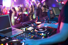 DJ Doing Record Scratching In Nightclub