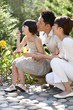 © Blue Jean Images - Family blowing Bubbles in garden