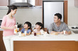 © Blue Jean Images - Happy family having breakfast