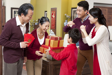 Wall Mural - Family visiting with gifts during Chinese New Year