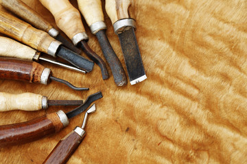 Wall Mural - carving tool closeup on wooden background