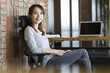 © Blue Jean Images - Young woman sitting in office