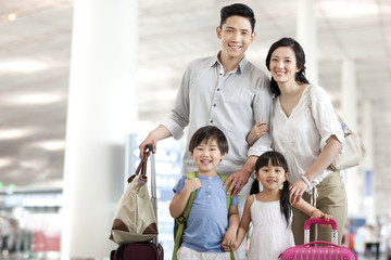 Happy young family at the airport